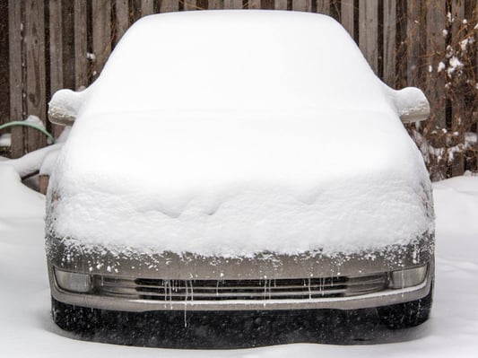 A vehicle covered in snow.