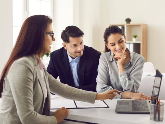 A couple talking through home design options with an interior designer.