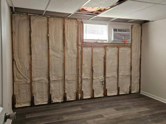 Closed cell spray foam insulation installed in an exterior wall during a home remodel.