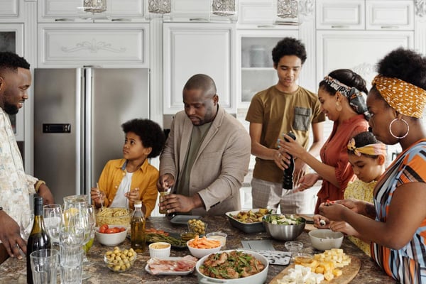 A family gathered in a kitchen to share a meal.