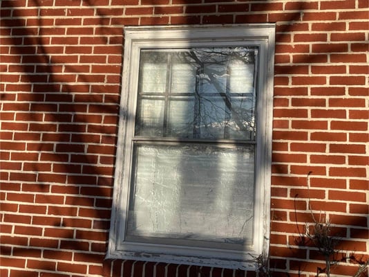 A foam panel installed in an older, single-pane window to insulate during the cold winter.