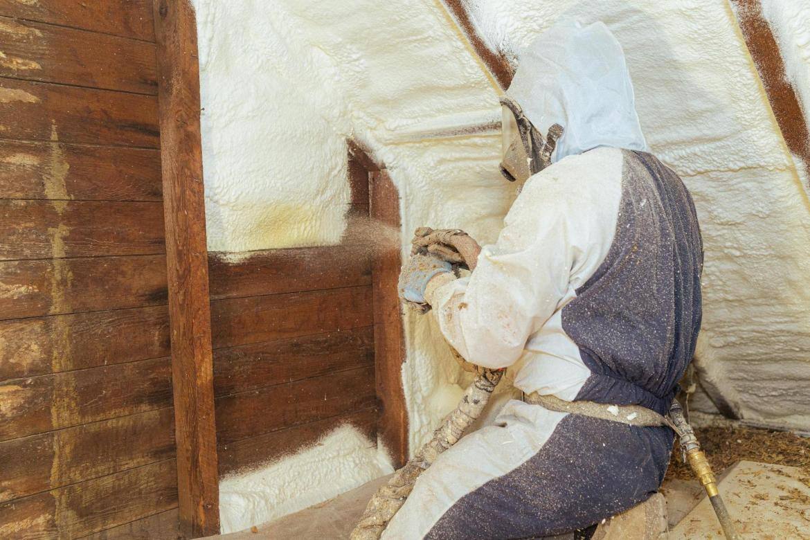 A South Central Services spray foam installer spraying closed cell foam onto an attic gable of a historic home located in Chambersburg, Pennsylvania.