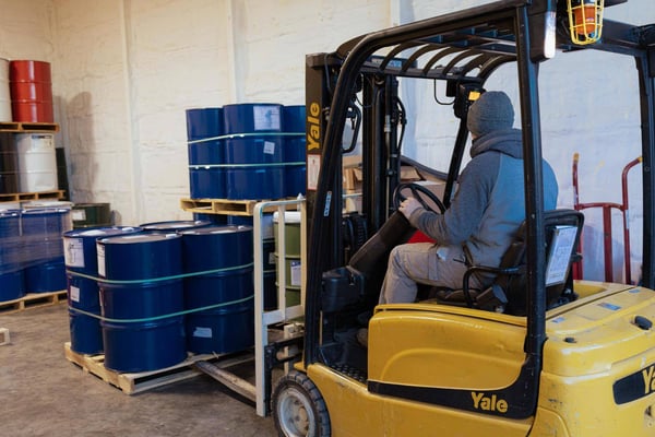 A crew member at South Central Services moving spray foam component drums out of the shop at their headquarters in Greencastle.