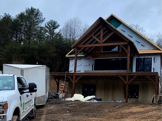 A new construction home with house wrap on the exterior.