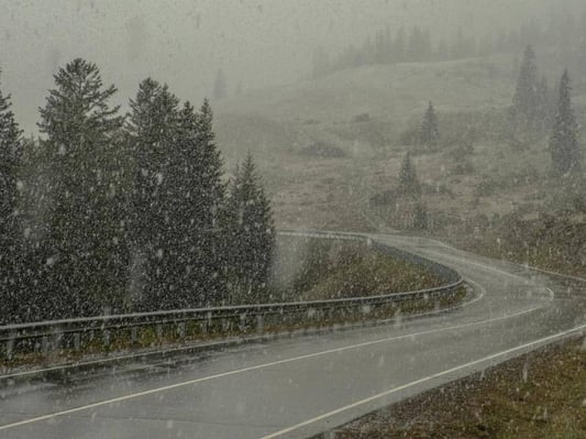 A highway in the winter with heavy snowfall.