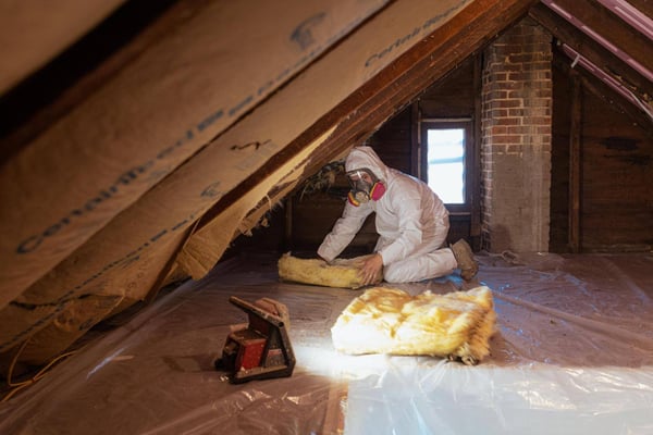 A spray foam contractor removing ineffective batt insulation from an attic in Chambersburg, Pennsylvania.