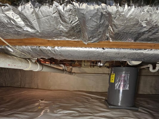 HVAC equipment and plumbing located in an encapsulated crawl space.