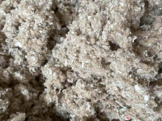 A close-up view of loose-fill cellulose insulation.