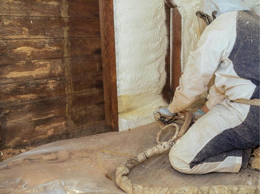 A spray foam contractor encapsulating an attic in Chambersburg, Pennsylvania with closed cell spray foam. The spray foam creates an airtight seal.