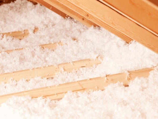 An attic insulated with blown-in fiberglass insulation.