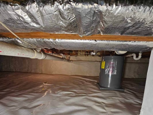 An encapsulated crawl space with HVAC and plumbing running through.
