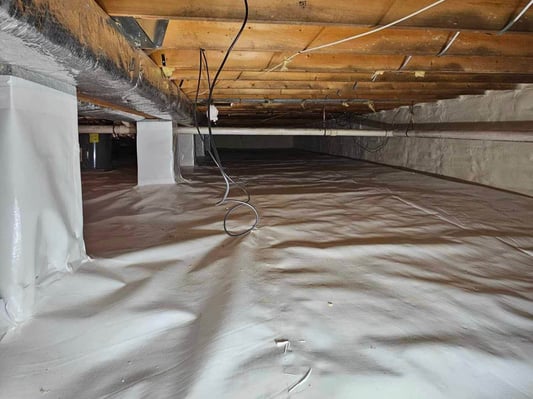An encapsulated crawl space in Franklin County, Pennsylvania. The crawl space pillars are wrapped in plastic sheathing as a vapor barrier.
