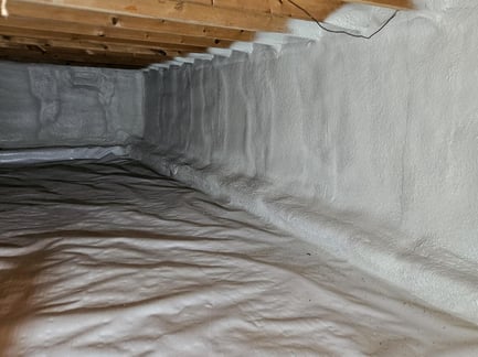 Walls and rim joists of a West Virginia crawl space insulated with closed cell spray foam.