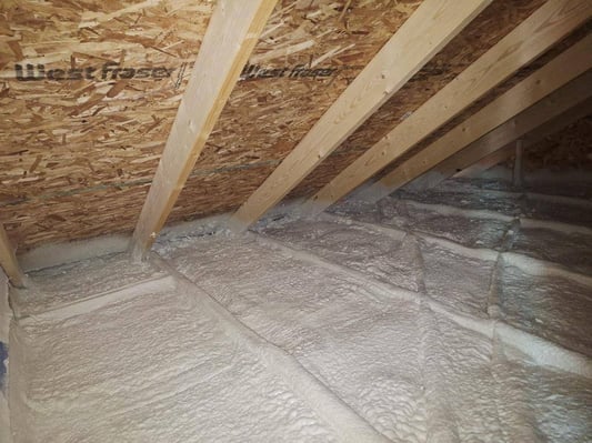 The corner of an attic insulated with closed cell spray foam insulation.