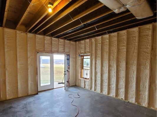 The basement of a new construction home where the basement walls are insulated with spray foam.