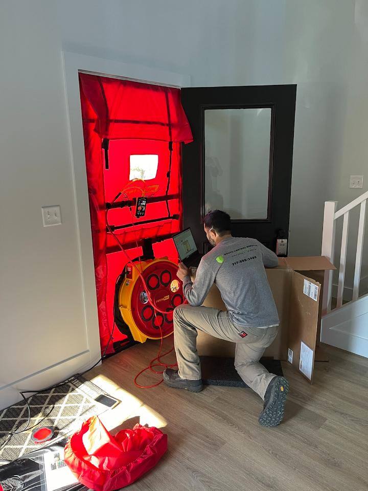 A contractor at South Central Services completing a blower door test in a new construction home.