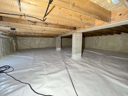 An encapsulated crawl space with closed cell spray foam on the walls and a vapor barrier on the floor.