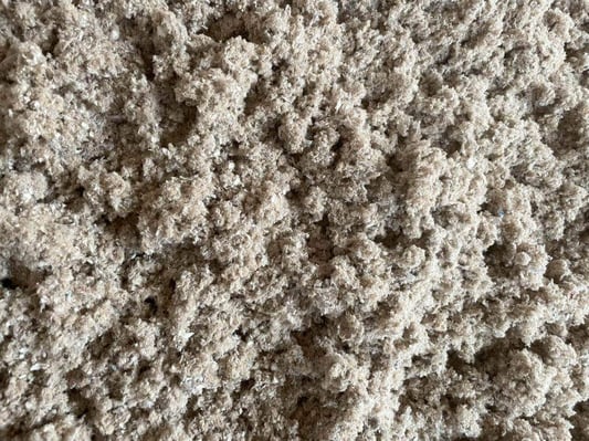 A layer of loose fill cellulose insulation, which can be installed as a blown-in insulation in attics or as a dense pack insulation in wall cavities.