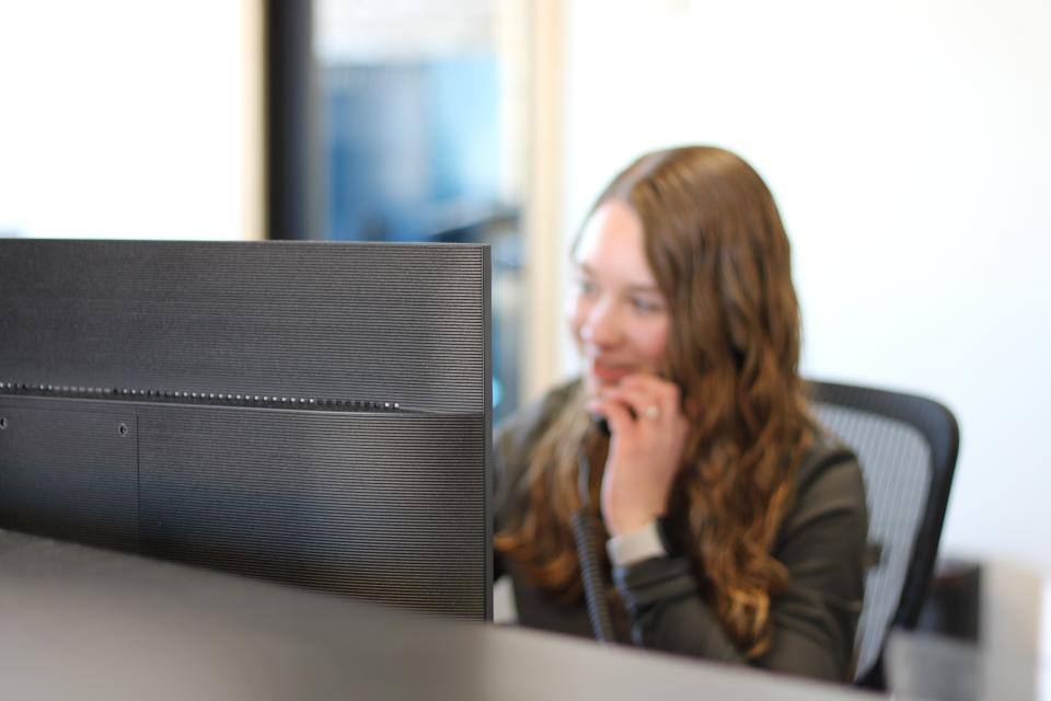 The receptionist at South Central Services Insulation speaking with a customer on the phone.